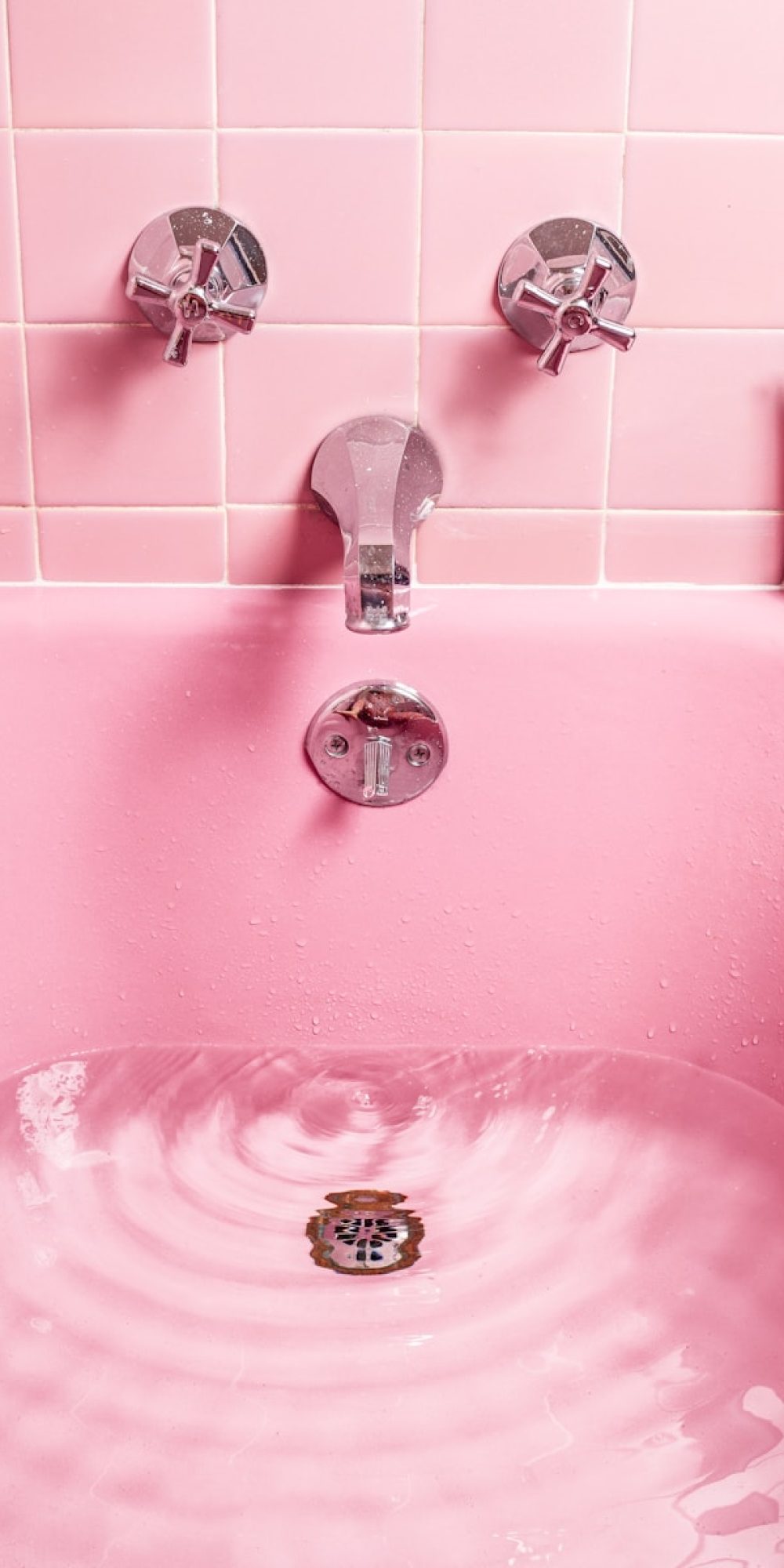 white bathtub filled with water